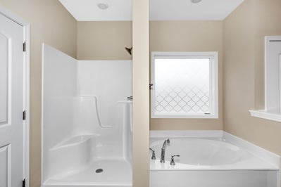 Spacious bathtub and shower space in the master bath of the Lexington home.